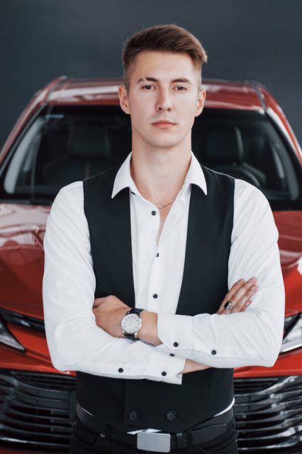 a-young-handsome-businessman-is-standing-by-the-ca-2021-08-29-00-35-39-utc.jpg