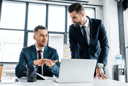 handsome-businessman-talking-with-coworker-in-mode-2022-12-16-15-25-11-utc.jpg