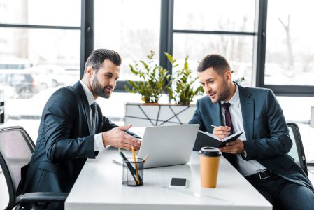 handsome-businessman-talking-with-coworker-while-h-2022-12-16-21-35-59-utc.jpg