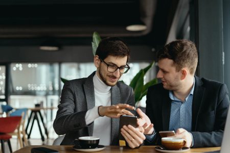 two-businessmen-having-a-conversation-using-a-smar-2021-08-28-12-41-56-utc.jpg