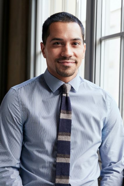 young-hispanic-business-man-smiling-to-camera-PGJV4CK.jpeg